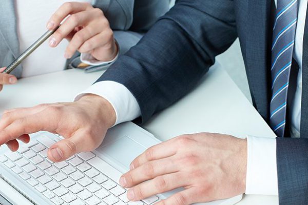 Group of business people working with laptop at meeting